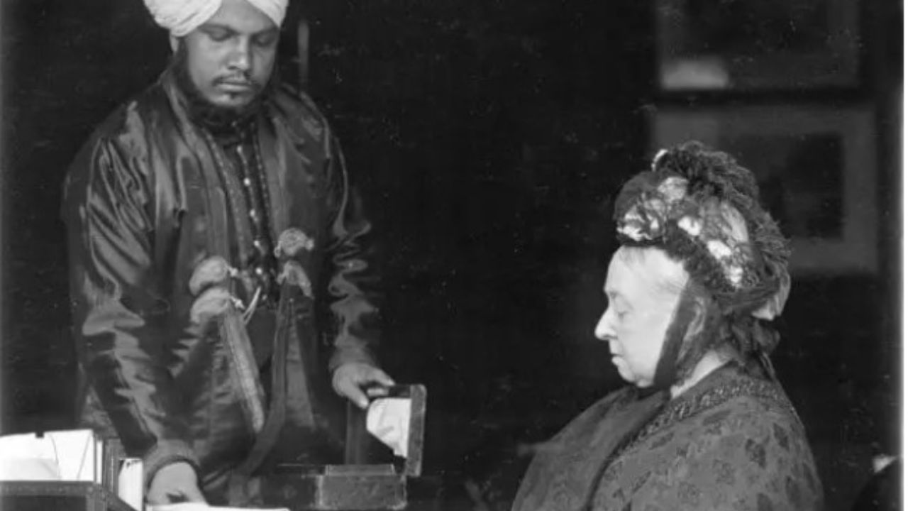 Regina Vittoria seduta alla scrivania